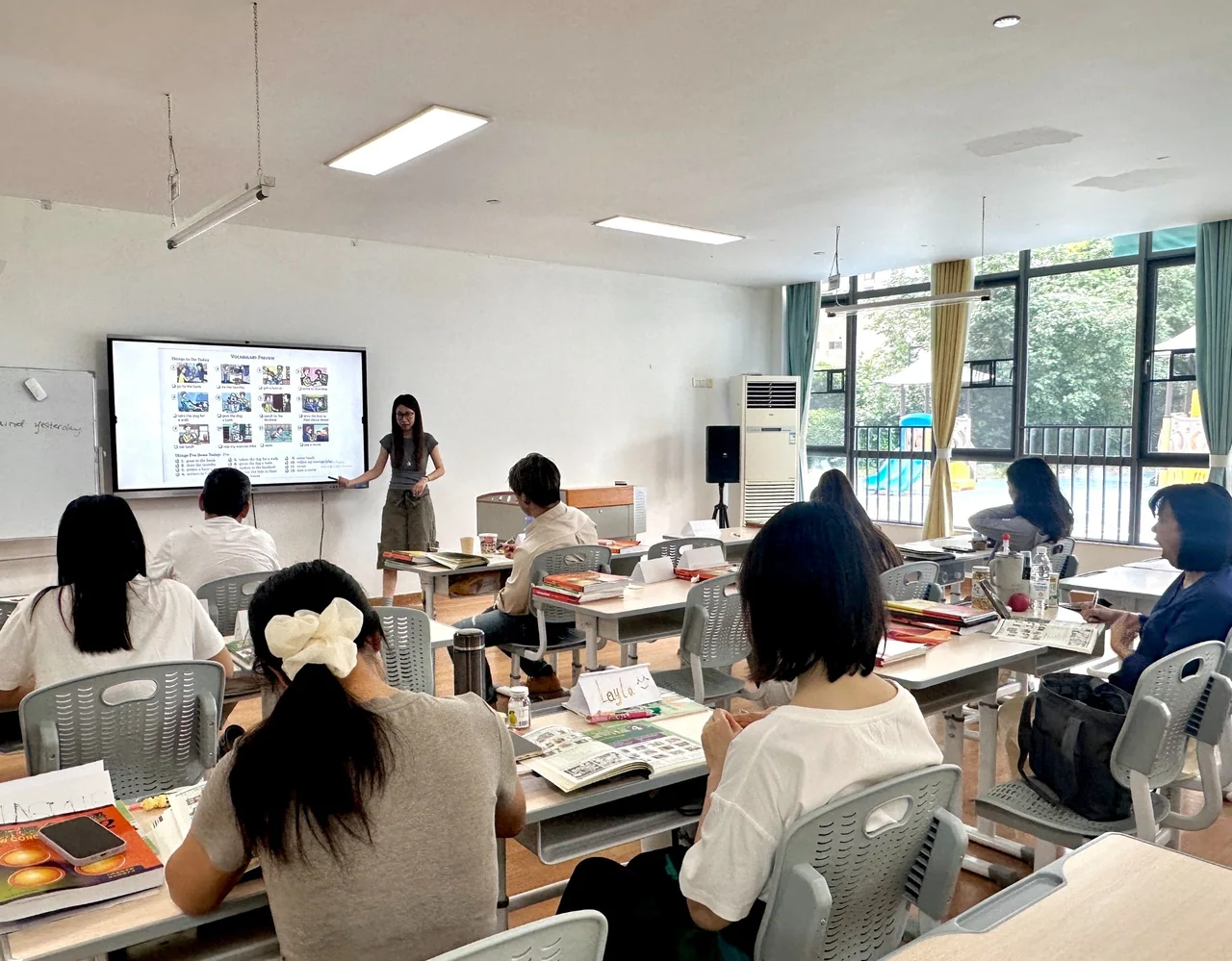 赛思中教课堂,教师结合屏幕内容讲解,学员在座位上学习